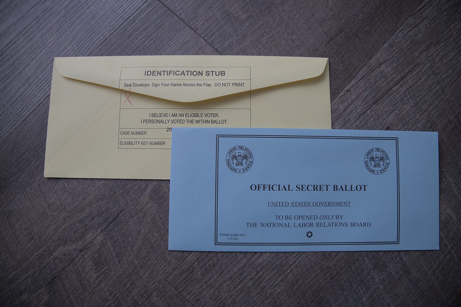 Blue and yellow mail-in ballot envelopes